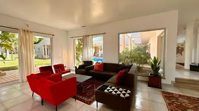 a living room with a couch and red chairs at Seventies by Check-in Portugal in Quarteira