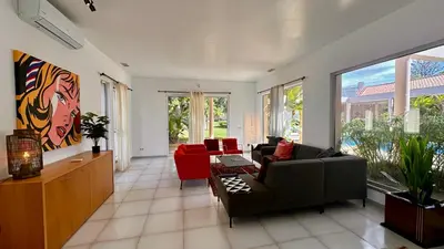 a living room with a couch and red chairs at Seventies by Check-in Portugal in Quarteira