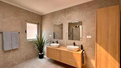 a bathroom with two sinks and a mirror at Seventies by Check-in Portugal in Quarteira