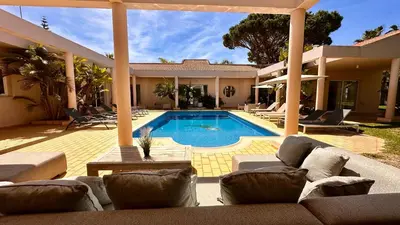 a house with a swimming pool in a yard at Seventies by Check-in Portugal in Quarteira