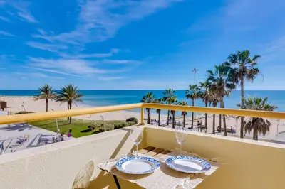 a balcony with a table and a view of the beach at InfiniteSeaView - Quarteira at Homesbyfc in Quarteira