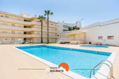 a swimming pool in front of a building at #055 São José V by Home Holidays in Albufeira