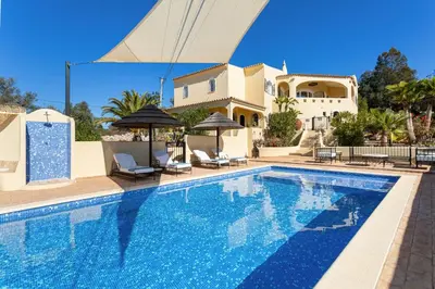 a swimming pool in front of a villa at Casa Lusitania 19 in Faro