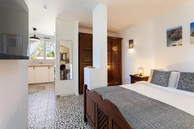 a bedroom with a large bed and a bathroom at Casa Lusitania 19 in Faro