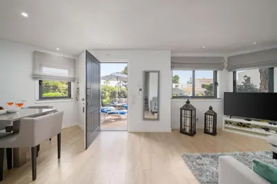 a living room with a dining table and a television at Casa Alessa - Vale de Lobo in Almancil
