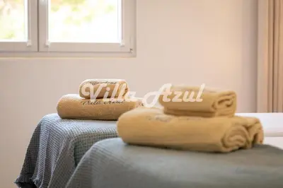 a pile of towels sitting on top of a table at Elegant villa with private pool in Quarteira in Vilamoura