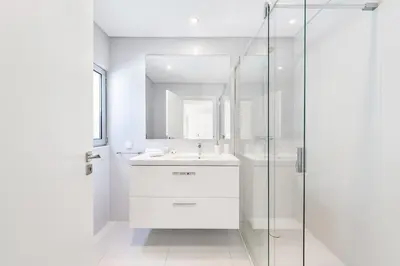 a white bathroom with a sink and a shower at ELLE Design Villa by OCvillas - Private Heated Pool and Jacuzzi in Albufeira