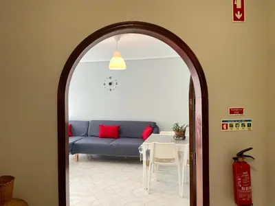 a living room with a blue couch and a table at Appartement T1 Albufeira Strip Oura in Albufeira