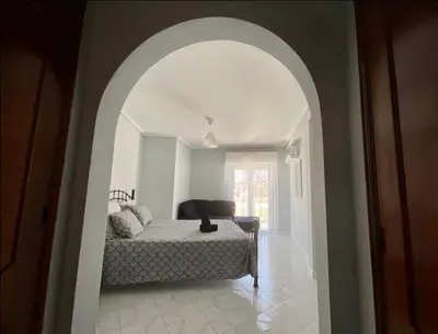 a bedroom with a bed in an arch way at Appartement T1 Albufeira Strip Oura in Albufeira