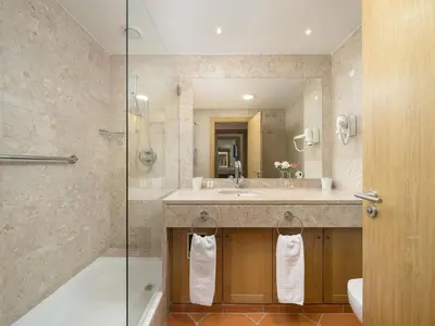 a bathroom with a tub and a sink and a shower at AL - Apartamento Vila Sol F5 L in Vilamoura
