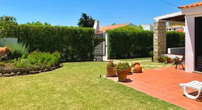 a garden with potted plants and a fence at LOTUS VILLA 2, ALBUFEIRA in Albufeira