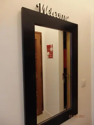a mirror with a black frame on a wall at Casa do Algarve in Albufeira