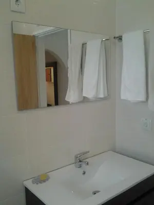 a white bathroom with a sink and a mirror at Casa do Algarve in Albufeira