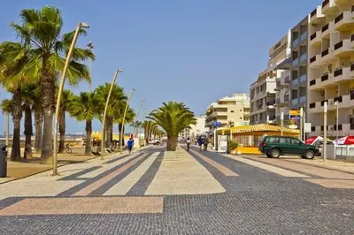 a sandy beach with a view of the ocean at RS Apartamento in Quarteira