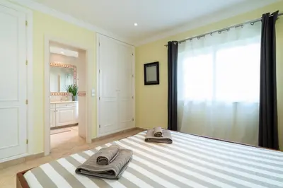 a bedroom with a bed with towels on it at Vale de Lobo by Intiholidays in Vale do Lobo