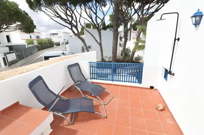two chairs and a table on a balcony at Seagull Rooftop Beach @150 m in Vale do Lobo