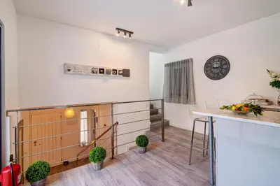 a kitchen with a counter and a clock on the wall at Casa Estrela do Mar in Vale do Lobo
