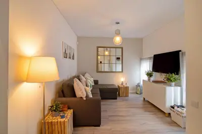 a living room with a couch and a tv at Casa Estrela do Mar in Vale do Lobo
