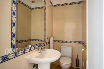 a bathroom with a sink and a toilet at Casa Valerie in Vale do Lobo
