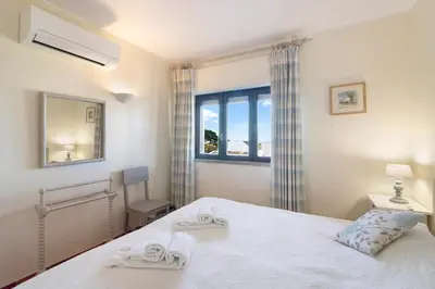 a bedroom with a bed with two towels on it at Casa Allan in Vale do Lobo