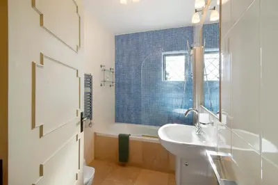 a bathroom with a white sink and a tub at Casa Allan in Vale do Lobo