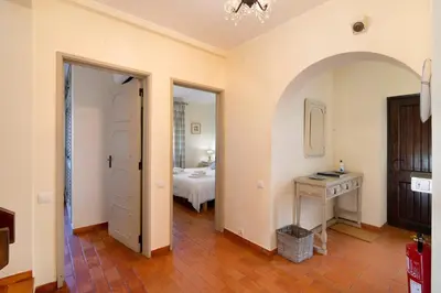 a room with a bedroom with a bed and a table at Casa Allan in Vale do Lobo