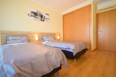 a hotel room with two beds in a room at Perfect New Apartment in Albufeira in Albufeira
