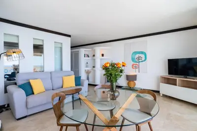 a living room with a couch and a glass table at Aveiros by the Sea by Intiholidays in Albufeira