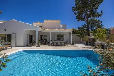 a large swimming pool in front of a house at Villa Falesia Blue by Villa Plus in Olhos de Água