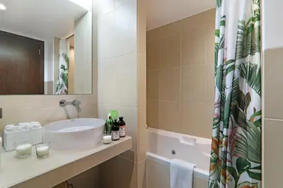 a bathroom with a sink and a tub at Salgados 4seasons Apartment in Albufeira