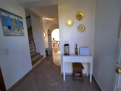 a stairway with a blue stool and a mirror at Villa Sunshine in Albufeira