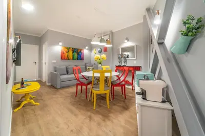 a kitchen and living room with a table and chairs at 7 Styles Apartments by Raspberry Cascade in Faro