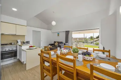 a kitchen and dining room with a table and chairs at Villa Amendoeira by Villa Plus in Albufeira