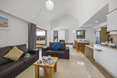 a living room with a couch and a table at Villa Amendoeira by Villa Plus in Albufeira