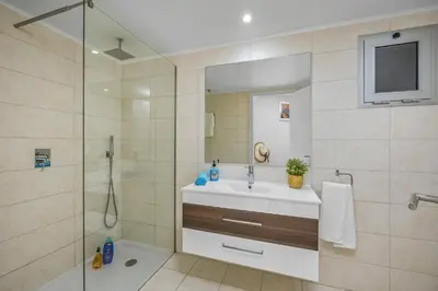 a bathroom with a sink and a shower at Villa Amendoeira by Villa Plus in Albufeira