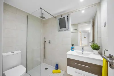 a bathroom with a shower and a toilet and a sink at Villa Buganvillea by Villa Plus in Albufeira