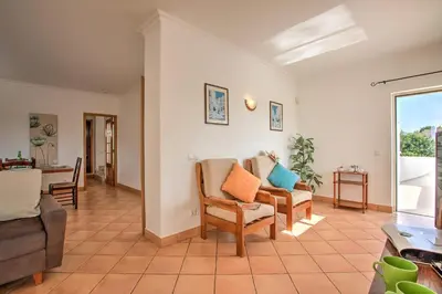 a living room with two chairs and a couch at Villa Papi by Villa Plus in Albufeira