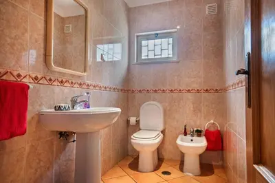 a bathroom with a toilet and a sink at Villa Papi by Villa Plus in Albufeira