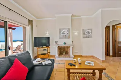 a living room with a couch and a fireplace at Villa Susana by Villa Plus in Albufeira