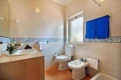 a bathroom with a toilet and a sink at Villa Susana by Villa Plus in Albufeira