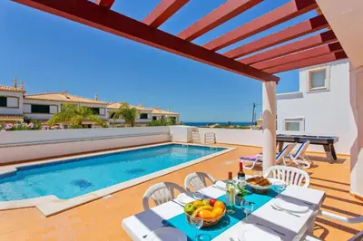 a living room with a couch and a table at Villa Susana by Villa Plus in Albufeira