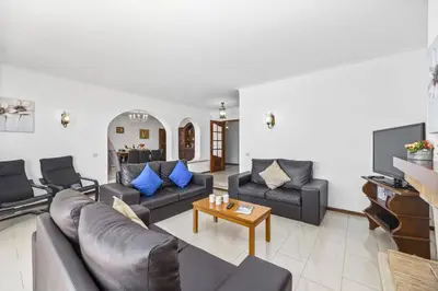 a living room with a couch and a table at Villa Zea by Villa Plus in Albufeira