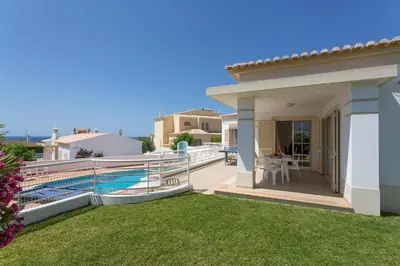 a villa with a balcony with a swimming pool at Villa Primavera by Villa Plus in Albufeira