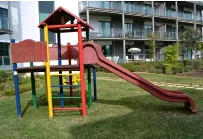 a playground with a slide in front of a building at Residence Golf Club-Vilamoura-Algarve in Vilamoura