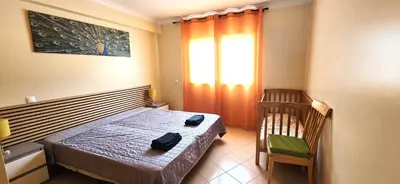 a hotel room with two beds and a window at Holidays - Albufeira in Albufeira