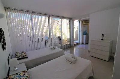 a bedroom with two beds and a large window at Happy Place - Albufeira in Albufeira