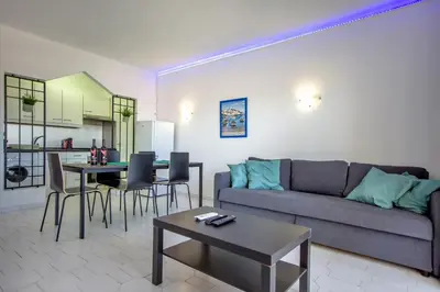 a living room with a couch and a table at Sea View Apartment - 3 Swimming Pool & Fitness in Albufeira