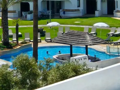 an overhead view of a swimming pool with an umbrella at Casa Anna Del Rey. sth.faceing with free wifi. in Albufeira