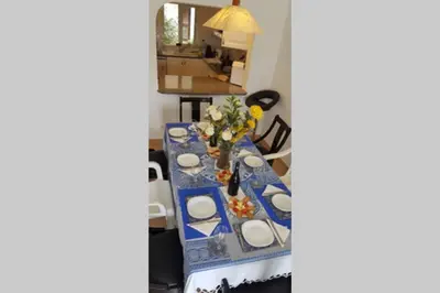 a blue and white table with plates and flowers on it at Casa Anna Del Rey. sth.faceing with free wifi. in Albufeira