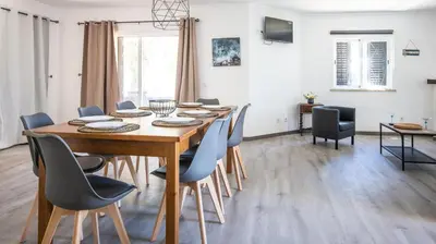 a dining room with a wooden table and chairs at Villa Pedro - Swimming Pool - BY BEDZY in Albufeira